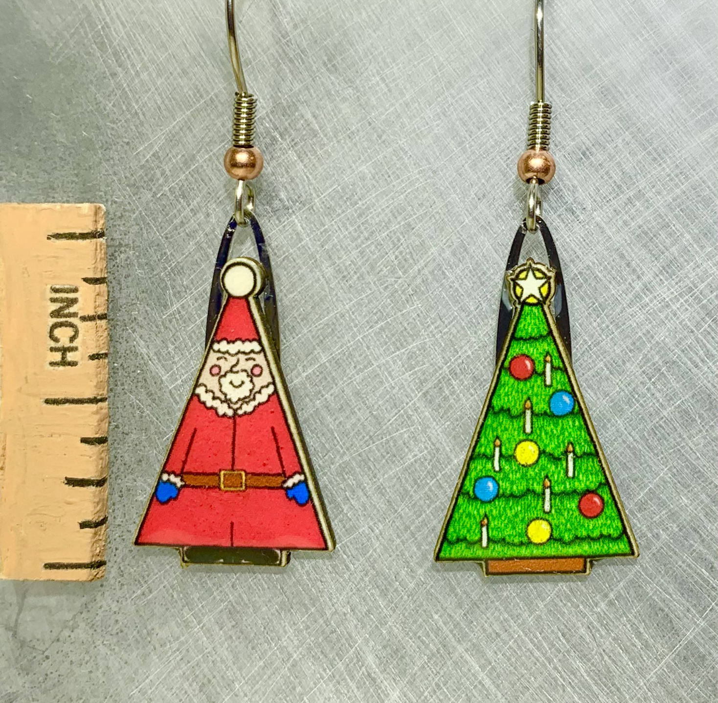 Picture shown is of 1 inch tall pair of earrings of Santa & Tree.