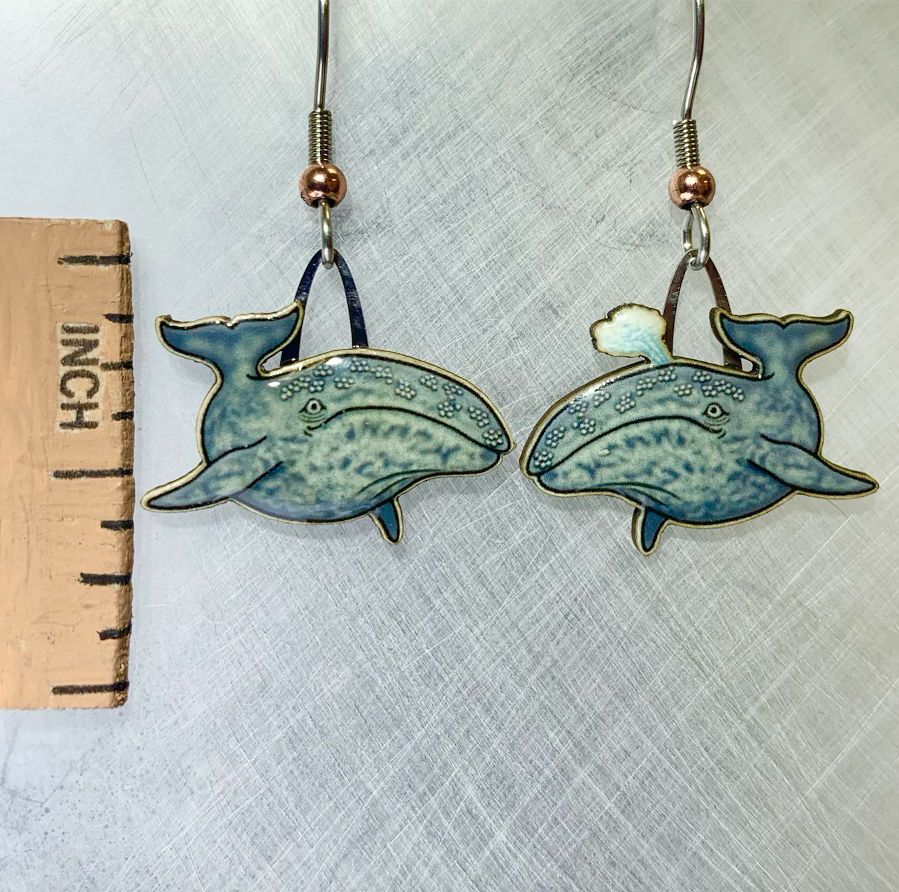 Picture shown is of 1 inch tall pair of earrings of the marine animal the Gray Whale.