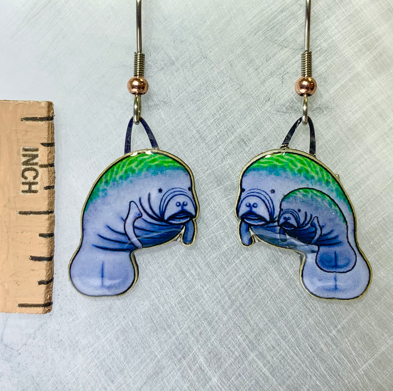 Picture shown is of 1 inch tall pair of earrings of the marine animal the Manatee.
