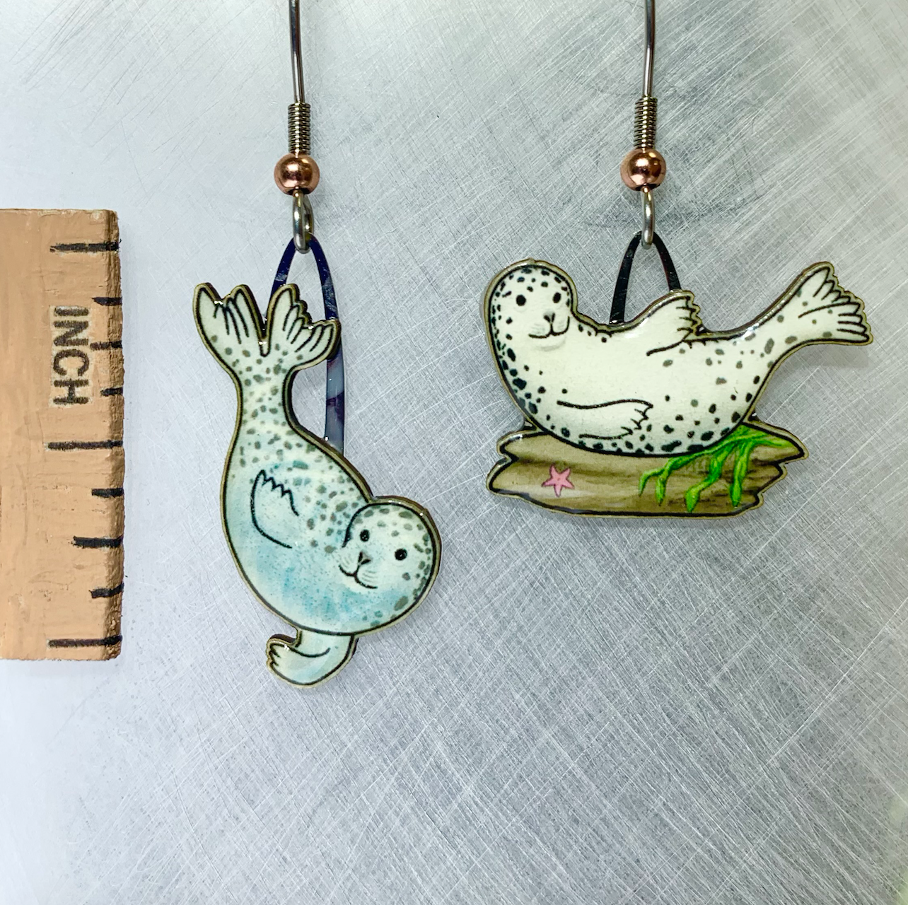 Picture shown is of 1 inch tall pair of earrings of the marine animal the Harbor Seal.