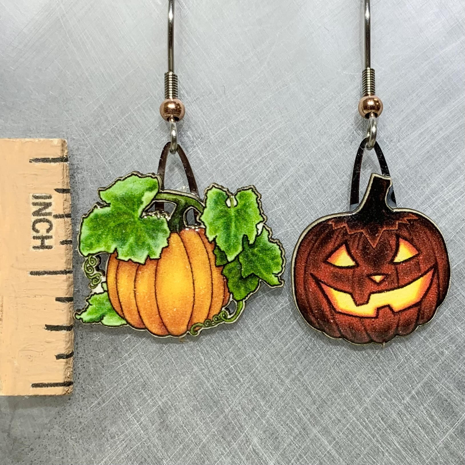 Picture shown is of 1 inch tall pair of earrings of a Jack-o-Lantern.