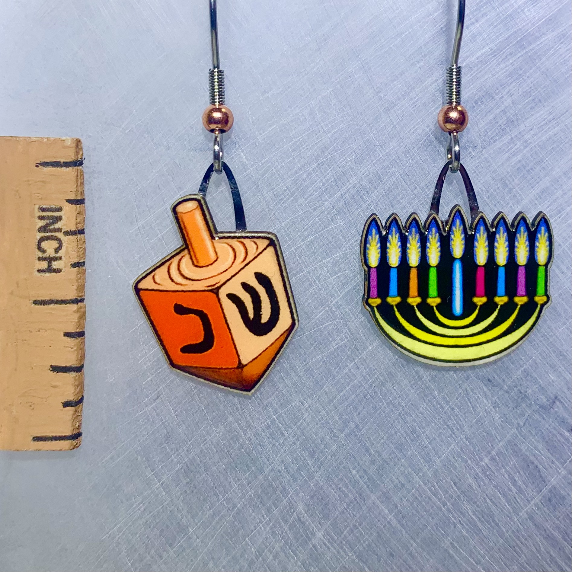 Picture shown is of 1 inch tall pair of earrings of Hanukkah Menorah.