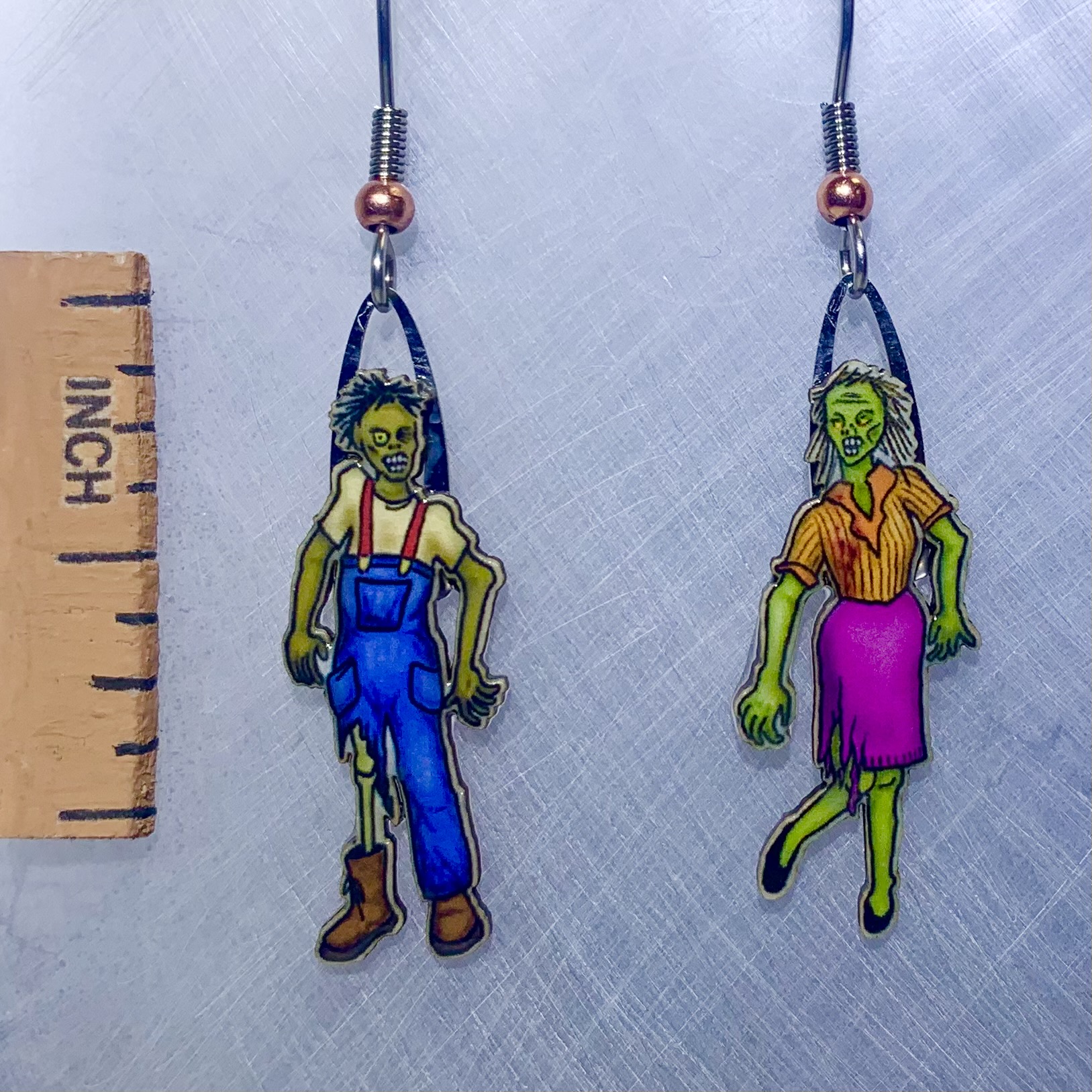 Picture shown is of 1 inch tall pair of earrings of Zombies.