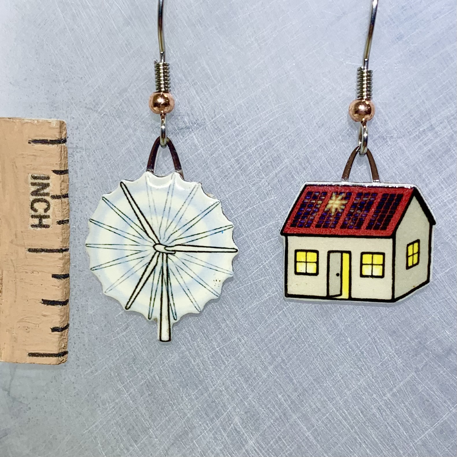 Picture shown is of 1 inch tall pair of earrings of Renewable Energy.