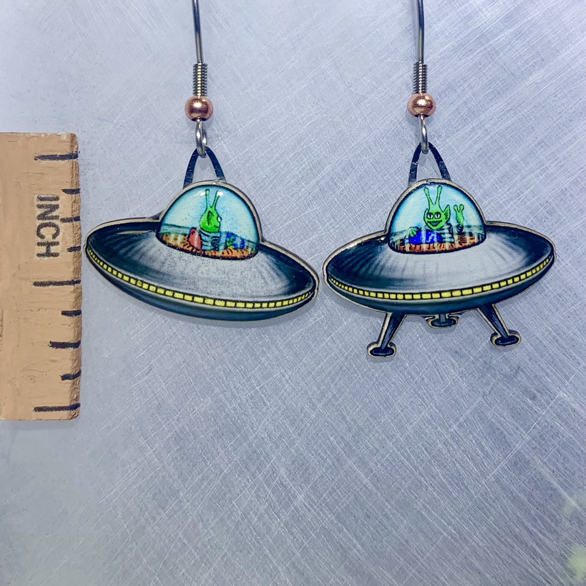 Picture shown is of 1 inch tall pair of earrings of UFOs.