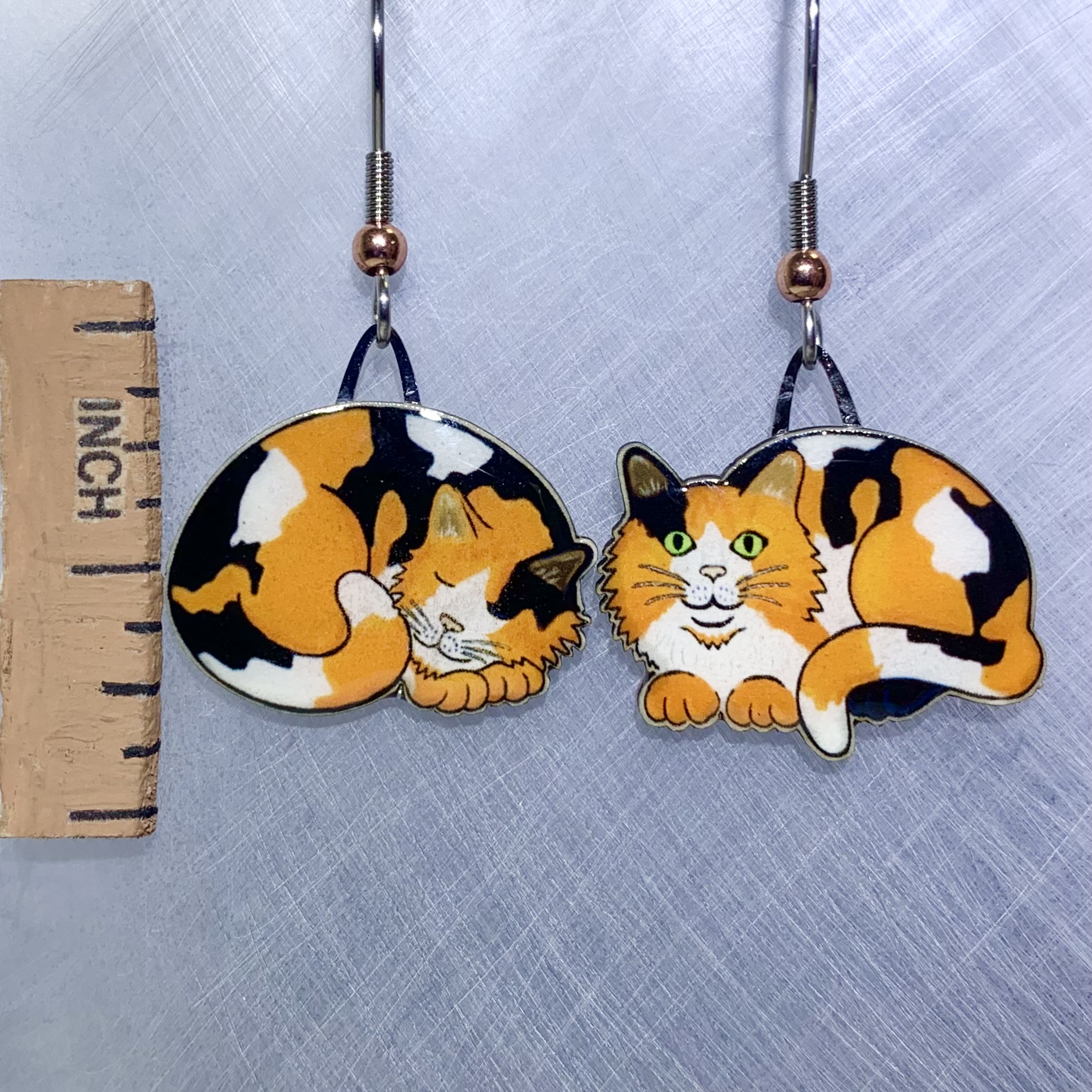 Picture shown is of 1 inch tall pair of earrings of the pet the Calico Napping Cat.