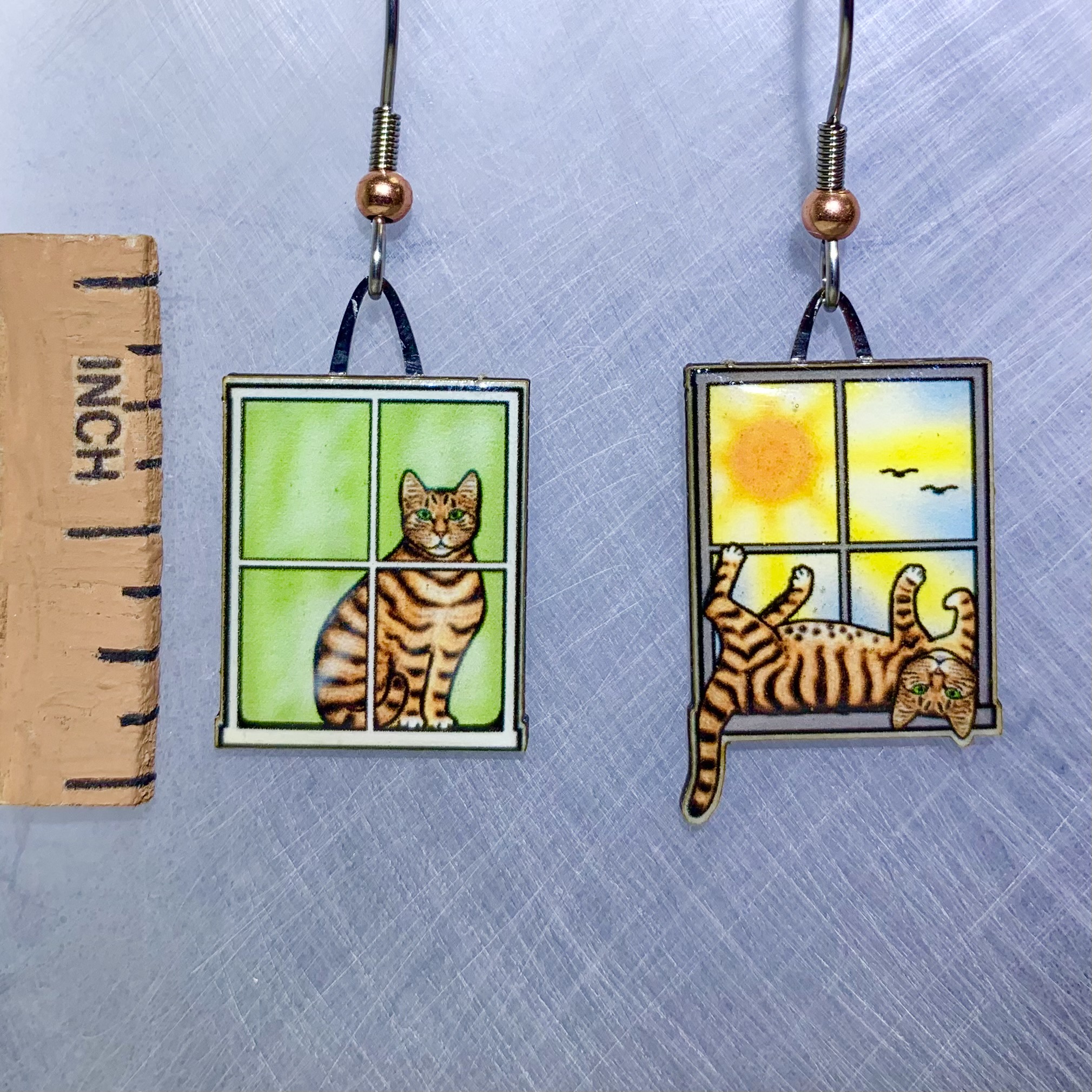 Picture shown is of 1 inch tall pair of earrings of the pet the Indoor Cat sitting on a window.
