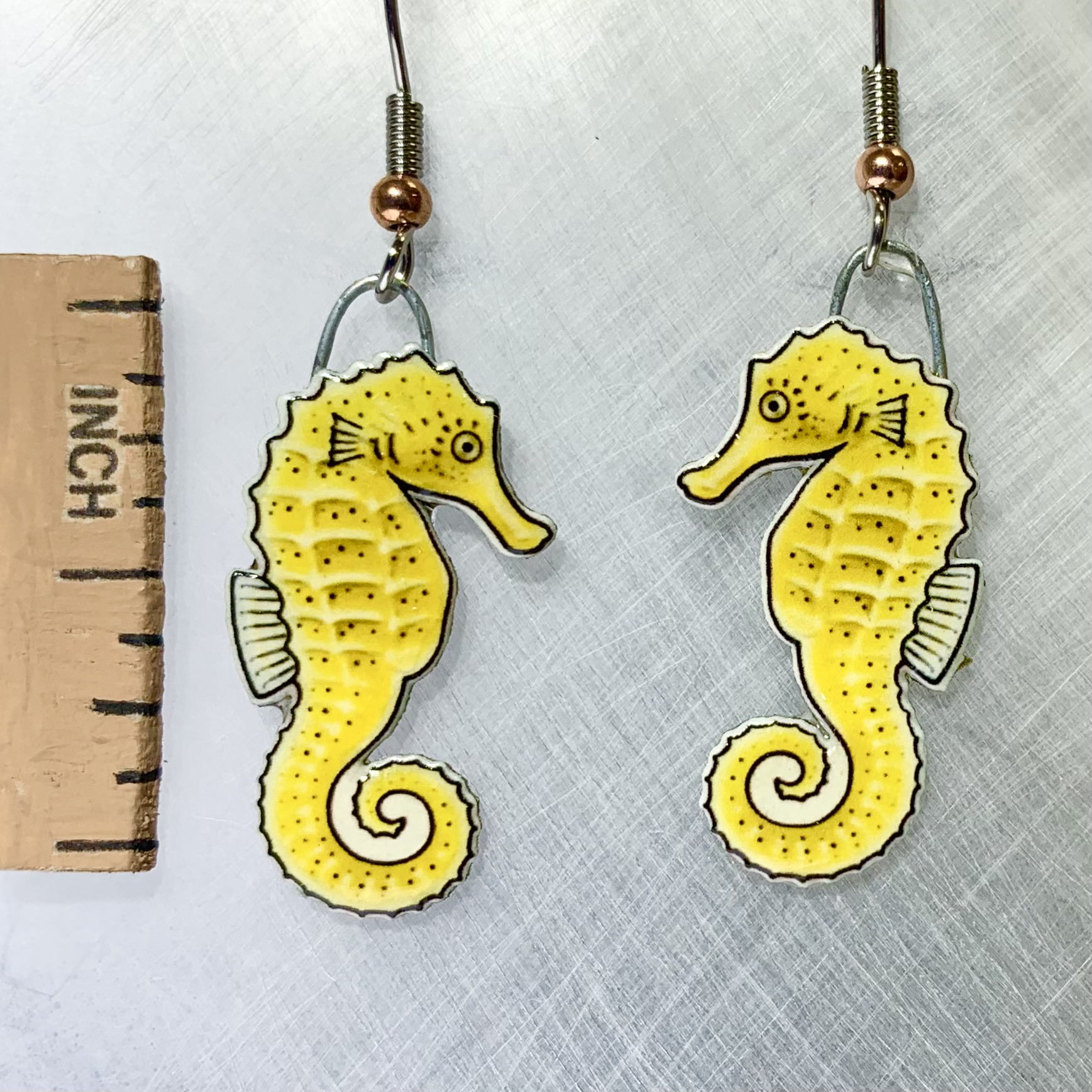 Picture shown is of 1 inch tall pair of earrings of the marine animal the Yellow Seahorse.