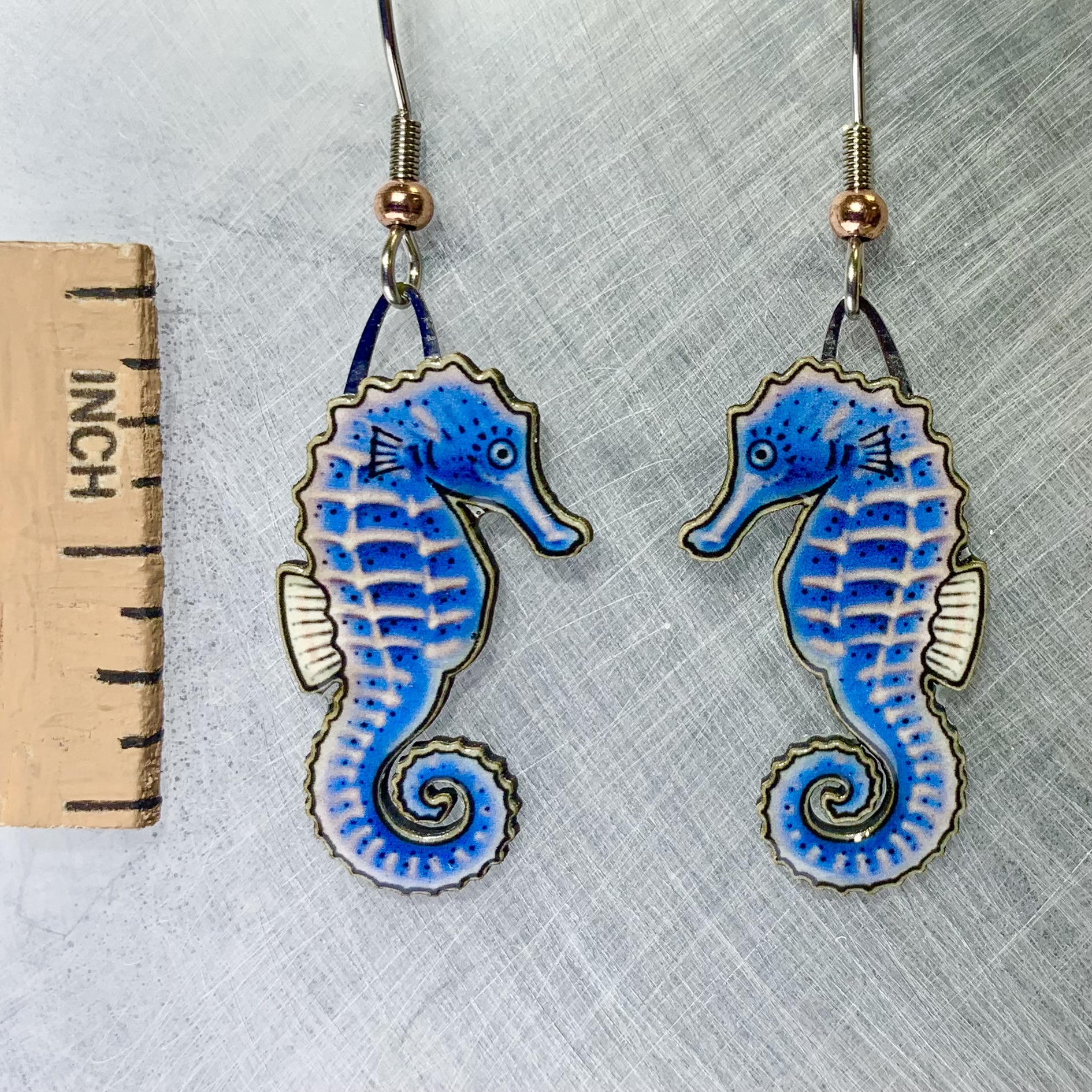 Picture shown is of 1 inch tall pair of earrings of the marine animal the Blue Seahorse.