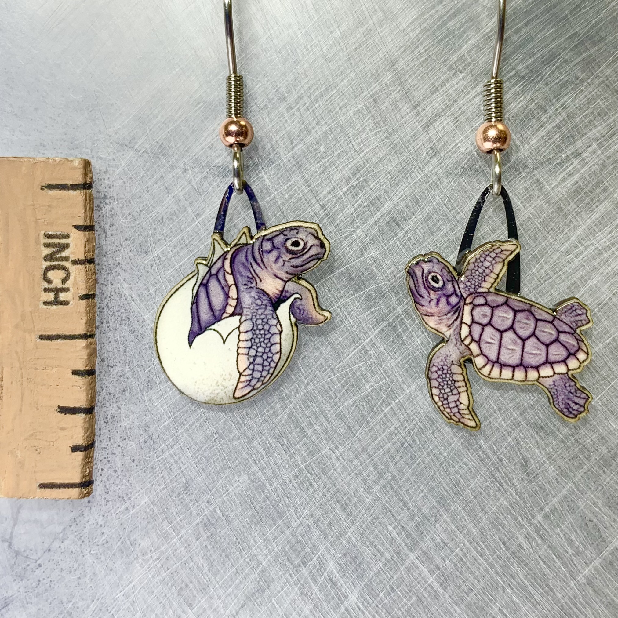 Picture shown is of 1 inch tall pair of earrings of the marine animal the Loggerhead Hatchling.