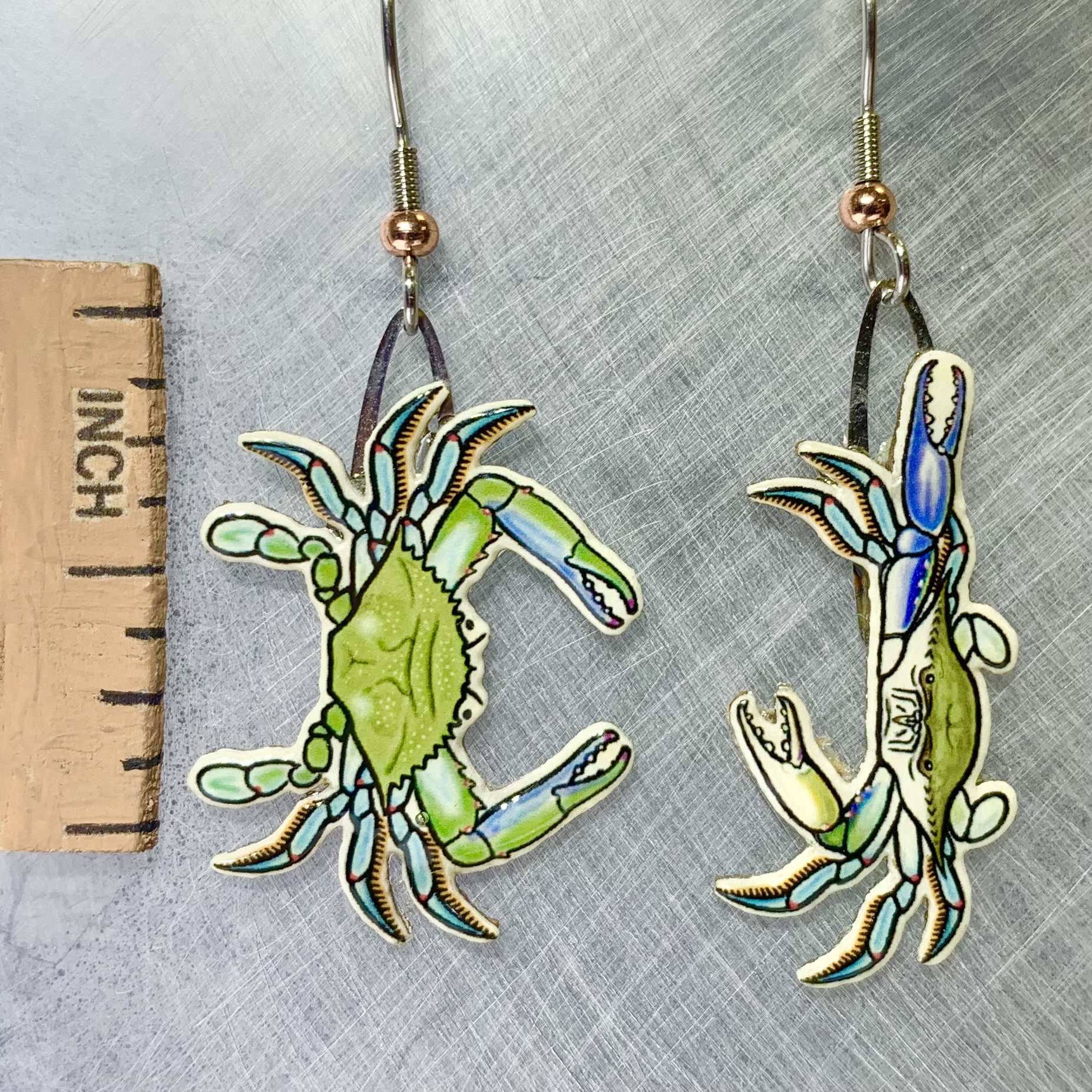 Picture shown is of 1 inch tall pair of earrings of the marine animal the Blue Crab.
