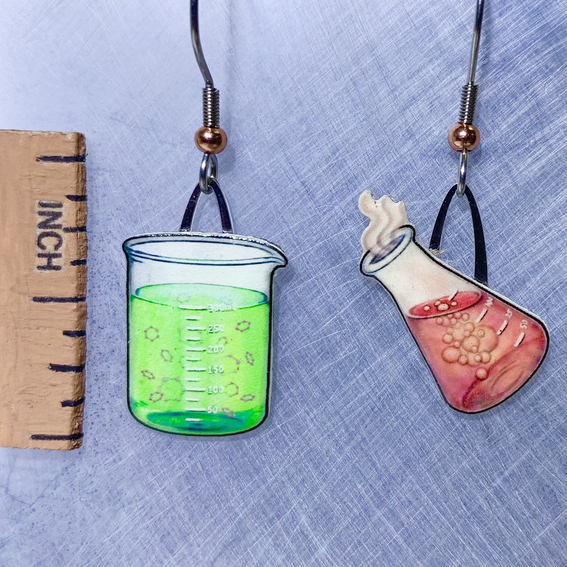 Picture shown is of 1 inch tall pair of earrings of Chemistry Glassware (Green & Red).