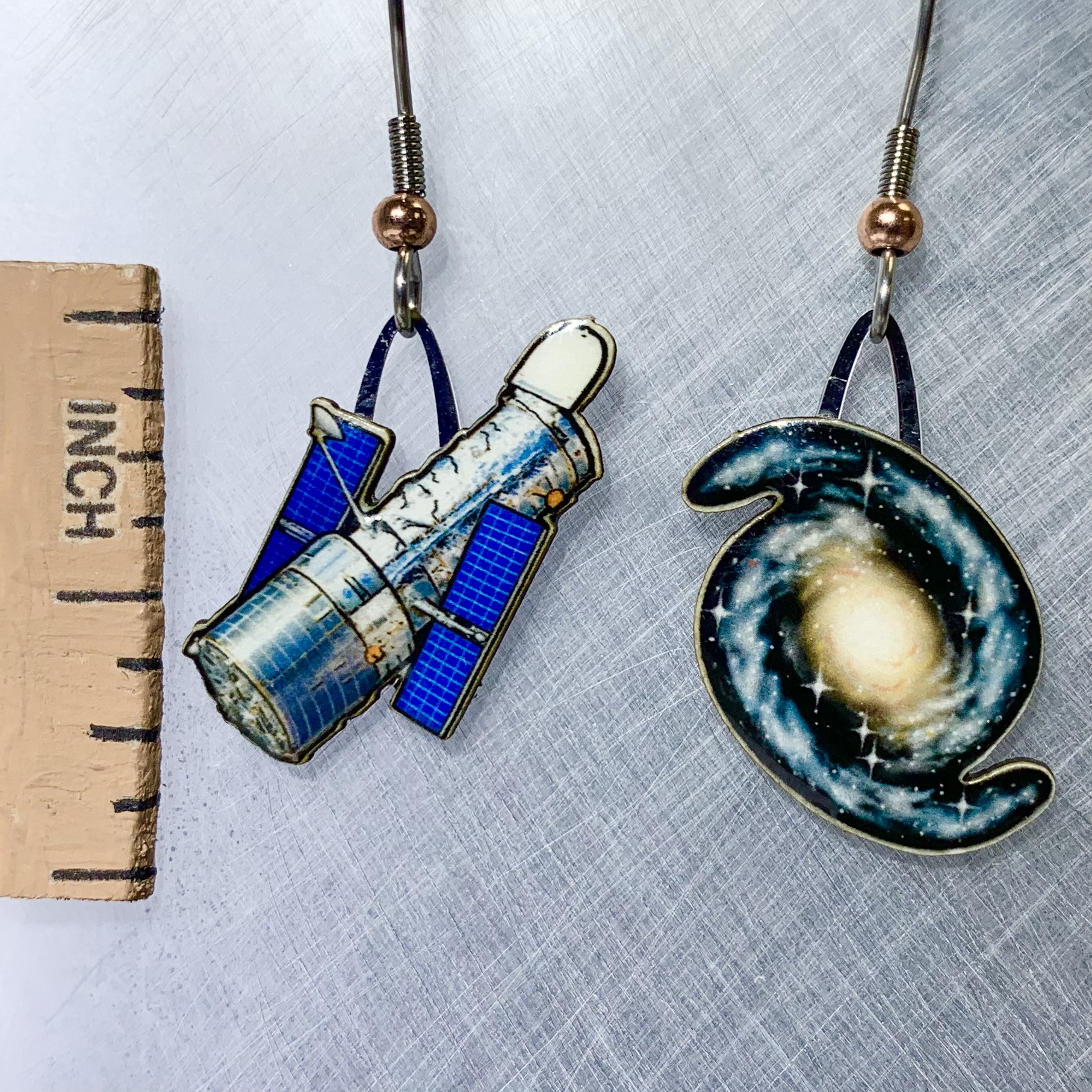 Picture shown is of 1 inch tall pair of earrings of the Hubble Telescope.