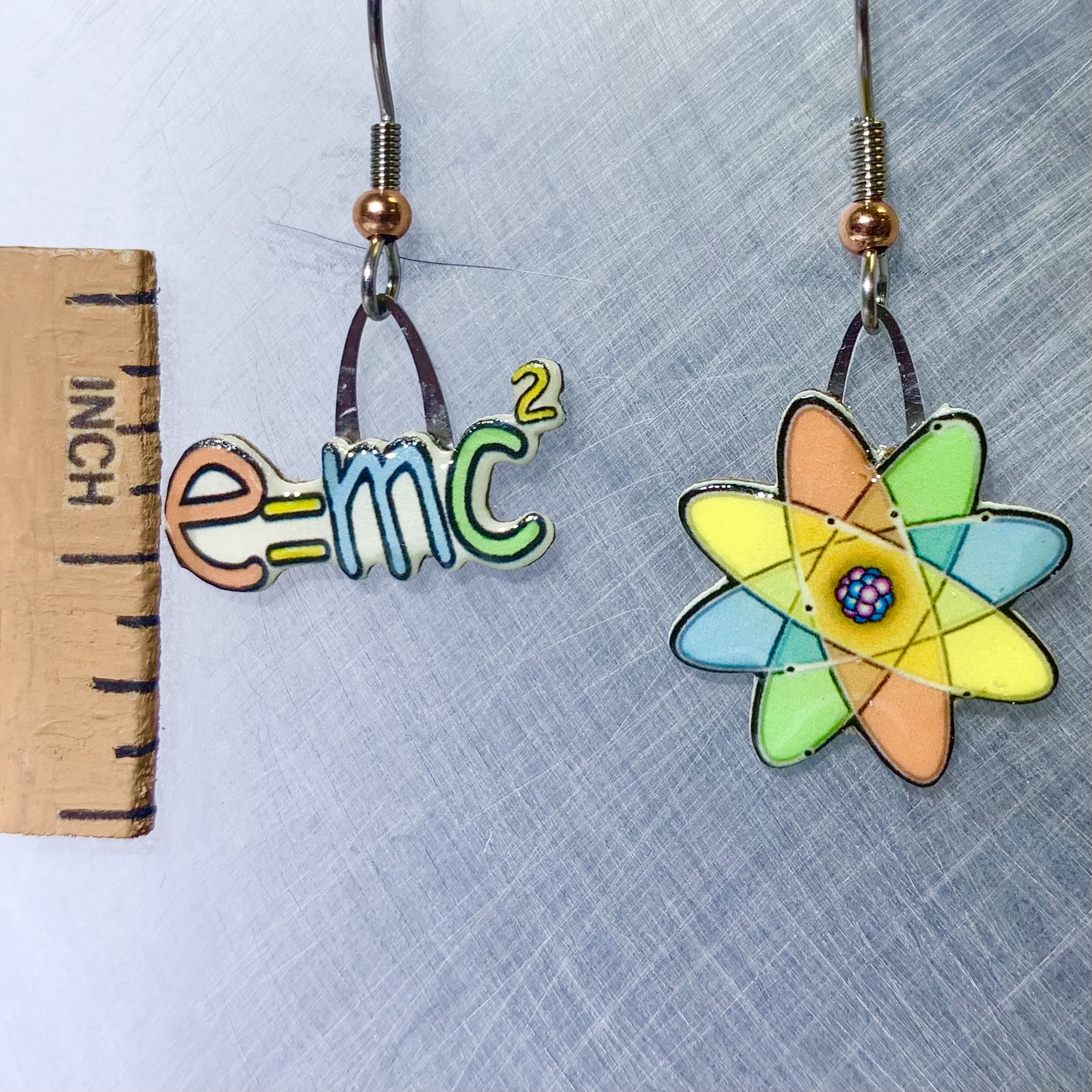 Picture shown is of 1 inch tall pair of earrings of Nuclear Science (Atom).