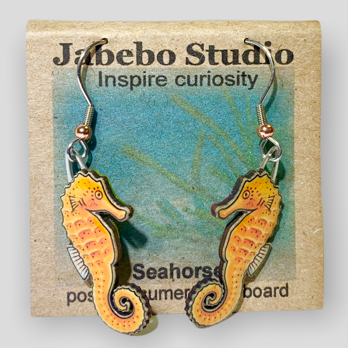 Picture shown is of 1 inch tall pair of earrings of the marine animal the Orange Seahorse.