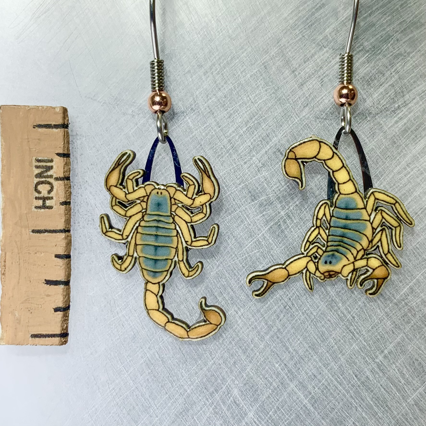 Picture shown is of 1 inch tall pair of earrings of the Scorpion.