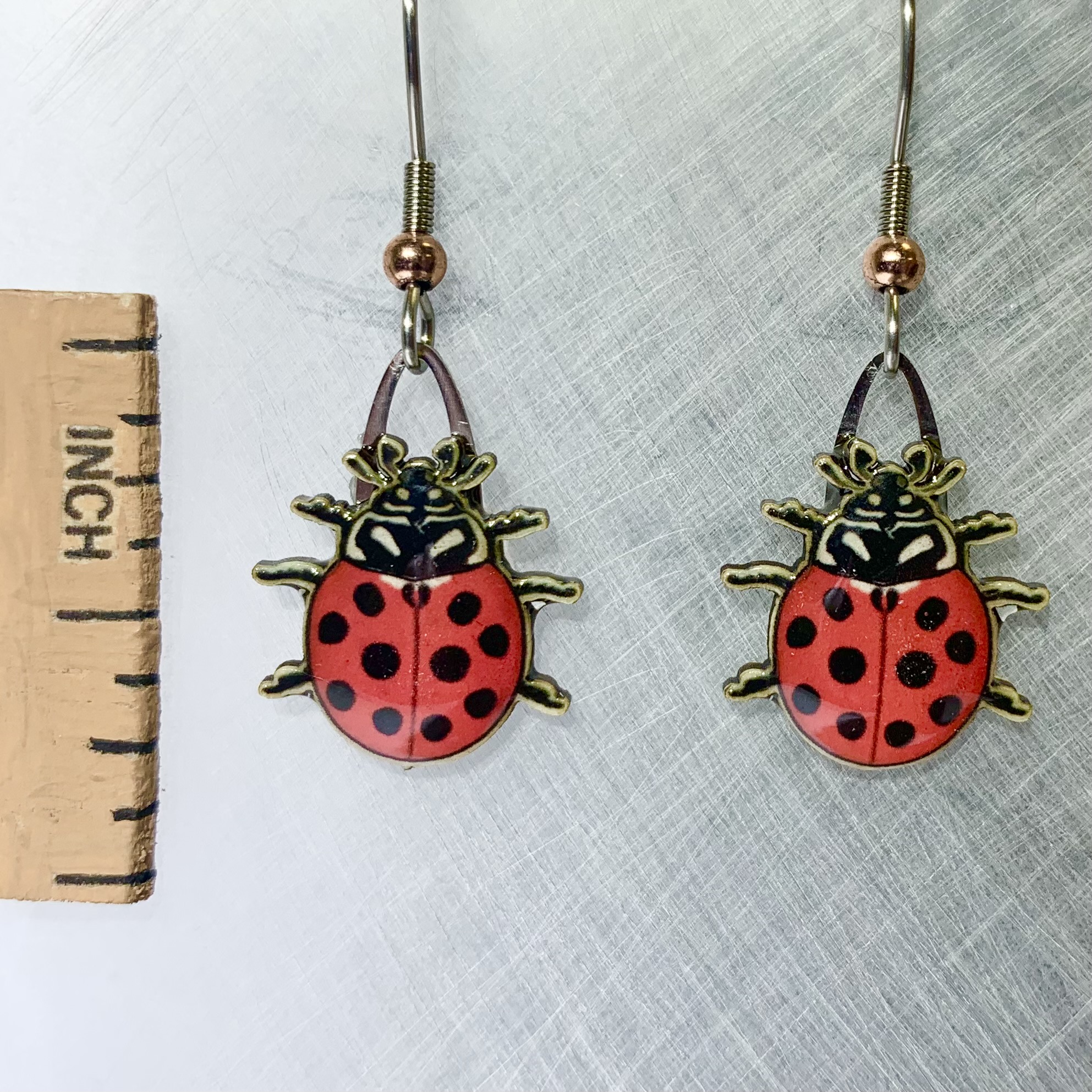 Picture shown is of 1 inch tall pair of earrings of the bug the Ladybug.