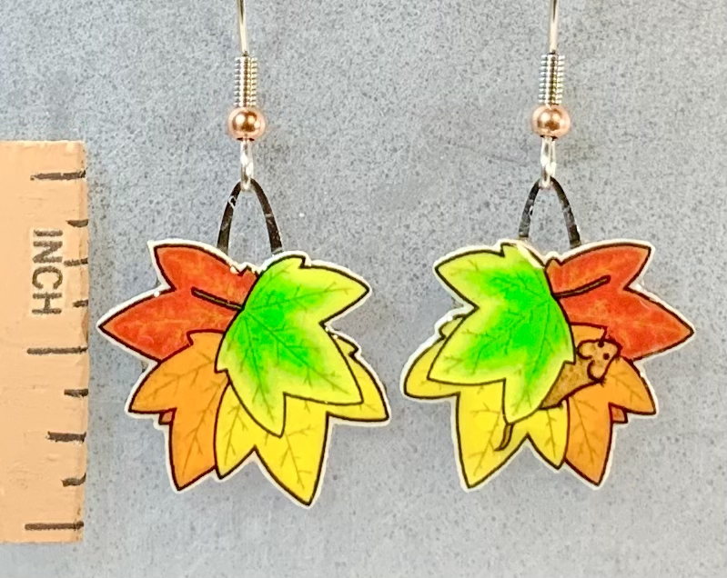 Picture shown is of 1 inch tall pair of earrings of Fall Leaves. Has tiny wild mouse in one leaf pile.